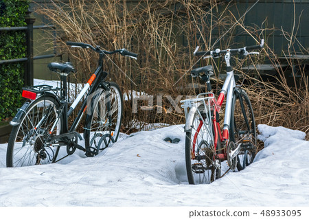 Bikes in the snow. 48933095