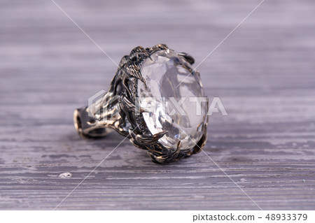 A silver ring with a cut stone from rhinestone A silver ring with a cut stone from rhinestone 48933379