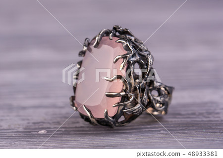 A silver ring with a large stone of rose quartz A silver ring with a large stone of rose quartz 48933381