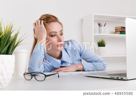 Portrait of tired office woman working by computer. Laptop problem. 48933580