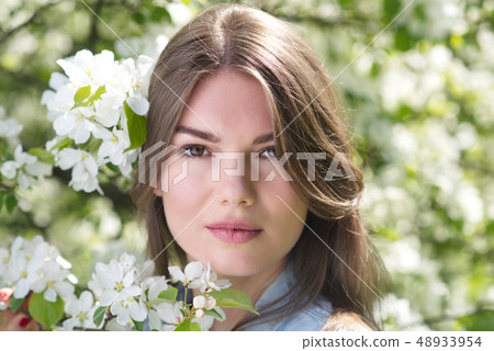 Woman near blooming apple tree Woman near blooming apple tree 48933954