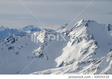 beautiful Alps mountain lanscape rocks under snow 48934316