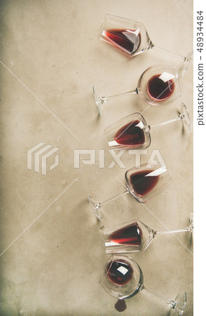 Red wine in glasses over grey concrete background 48934484