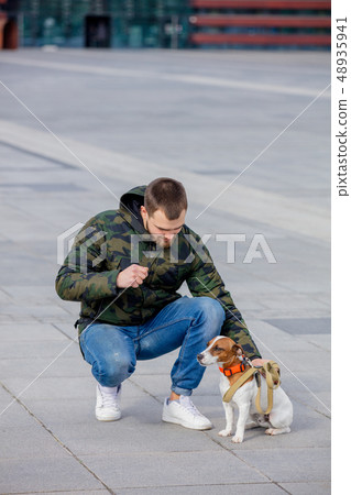 man with his dog, Jack Russell Terrier, on the city street man with his dog, Jack Russell Terrier, on the city street 48935941