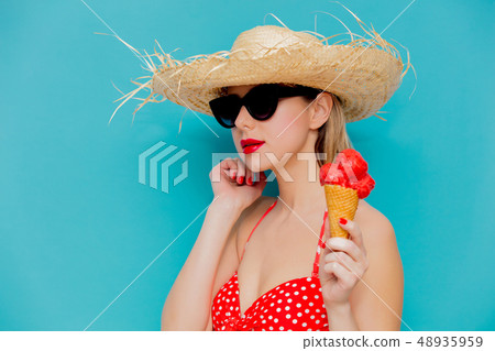 Young woman in red bikini and straw hat with ice cream  48935959