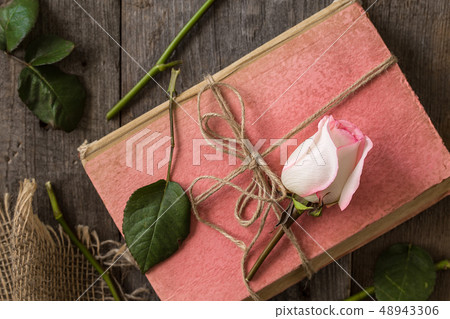 Pink rose on an old book in a vintage style Pink rose on an old book in a vintage style 48943306