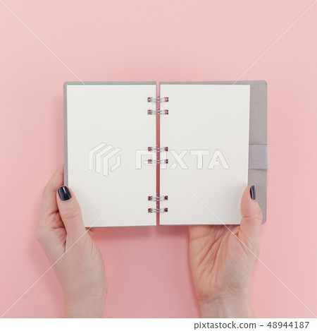 Woman hands with blank notepad mockup Woman hands with blank notepad mockup 48944187