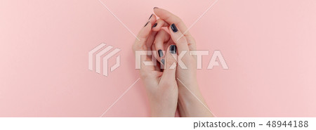 Woman's hands with black manicure Woman's hands with black manicure 48944188