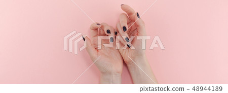 Woman's hands with black manicure Woman's hands with black manicure 48944189