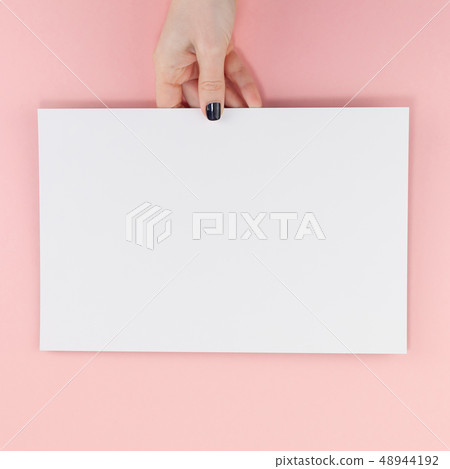 Woman hands with blank A4 paper sheet mockup Woman hands with blank A4 paper sheet mockup 48944192
