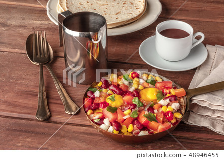 Mexican breakfast. Huevos rancheros, the fried eggs, with the pico de gallo salad, hot chocolate 48946455