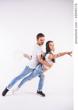 Passionate couple dancing social danse kizomba or bachata or semba or taraxia on white background 48946578