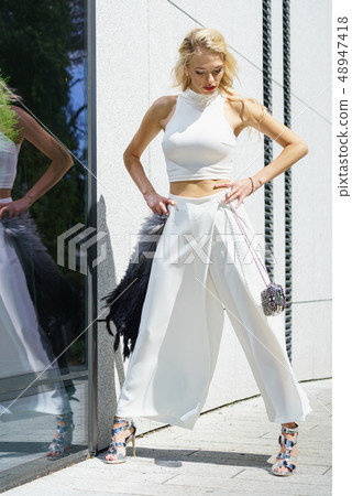 Woman wearing crop top and culottes Woman wearing crop top and culottes 48947418