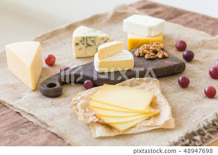 Various types of cheese, blue cheese and brie with grapes and nuts Various types of cheese, blue cheese and brie with grapes and nuts 48947698