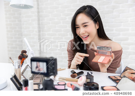 Pretty asian Blogger making a demonstration video 48948698