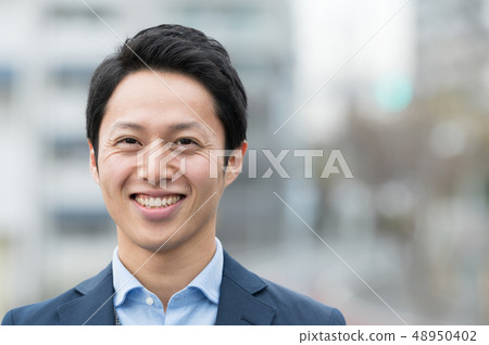 Young Japanese man standing outdoors Young Japanese man standing outdoors 48950402