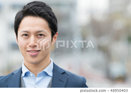 Young Japanese man standing outdoors 48950403