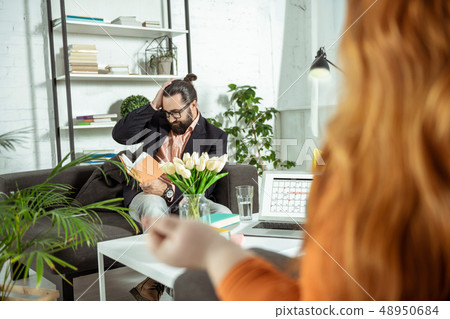 Attentive brunette male person staring at his notebook 48950684