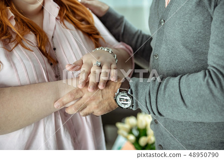 Close up of female person showing her jewelry 48950790