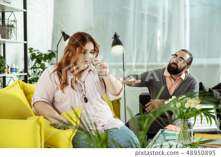 Handsome therapist discussing problems of his patient 48950895