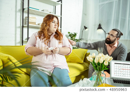 Negative delighted longhaired girl talking about her complexes 48950963