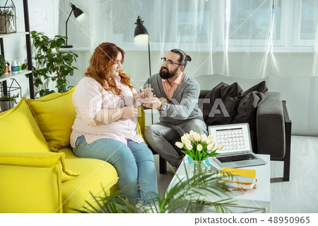 Attentive overweight female person listening to pieces of advise Attentive overweight female person listening to pieces of advise 48950965