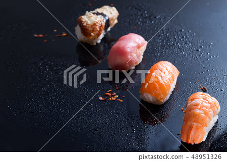 Sashimi, uramaki and nighiri, Japanese dish consisting of rice, salmon or tuna, shrimp in black with Sashimi, uramaki and nighiri, Japanese dish consisting of rice, salmon or tuna, shrimp in black with 48951326