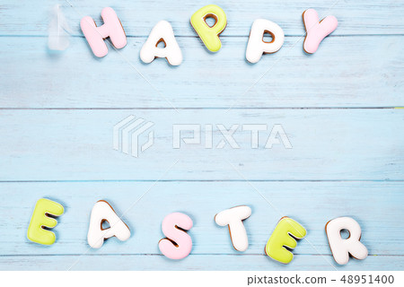 Delicious Easter cookies background. Eggs with different pattern icing on blue wooden background Delicious Easter cookies background. Eggs with different pattern icing on blue wooden background 48951400