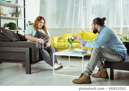 Upset young woman talking about her problem 48952093