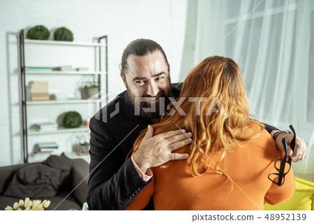 Positive delighted man caressing his plus size girlfriend Positive delighted man caressing his plus size girlfriend 48952139