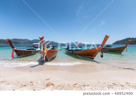 Wooden long-tail boats on crystal tropical sea 48952400