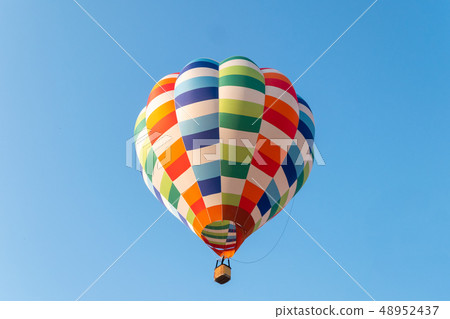 Hot air balloons flying in blue sky Hot air balloons flying in blue sky 48952437