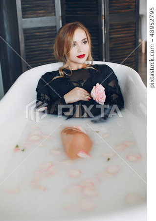 Stylish and beautiful girl lies in the bathroom 48952798