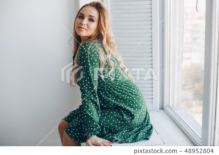 Beautiful young pregnant woman at home Beautiful young pregnant woman at home 48952804