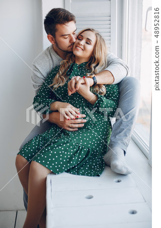 Elegant couple sitting in a studio 48952816