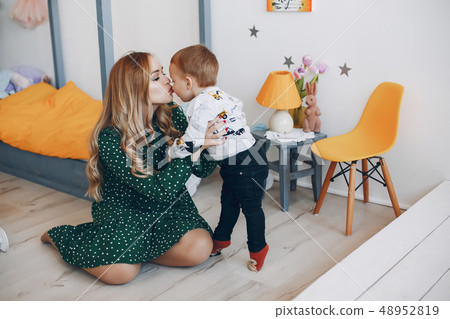 Mother sitting at home with little son Mother sitting at home with little son 48952819
