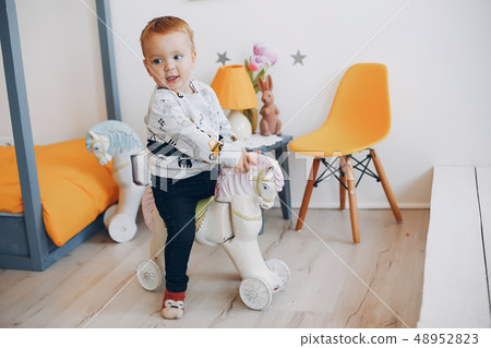 Cute little boy playing at home Cute little boy playing at home 48952823