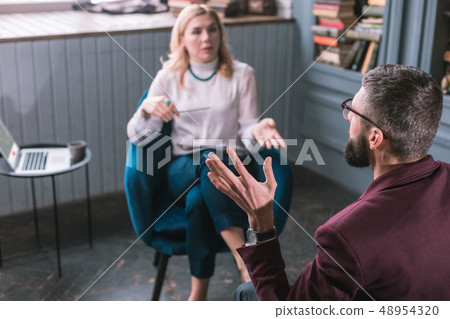 Top view of man having family problems talking to professional therapist Top view of man having family problems talking to professional therapist 48954320