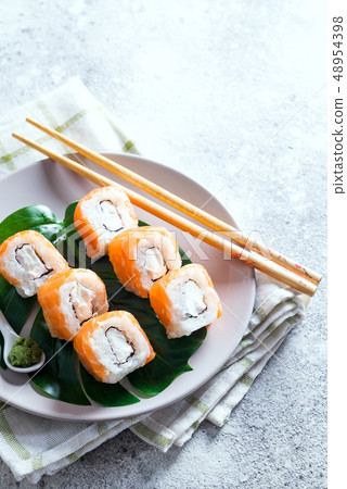 Philadelphia roll classic on a plate with chopsticks. Japanese sushi food. Copy space Philadelphia roll classic on a plate with chopsticks. Japanese sushi food. Copy space 48954398
