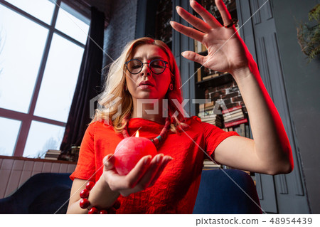 Astrologist wearing necklace and bracelet practicing future prediction 48954439