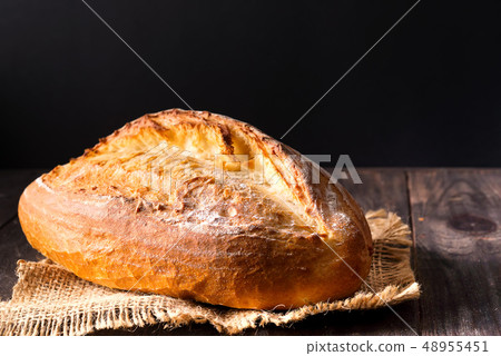 Rustic bread roll or french baguette, wheat and flour on wooden. Rural kitchen or bakery - 48955451