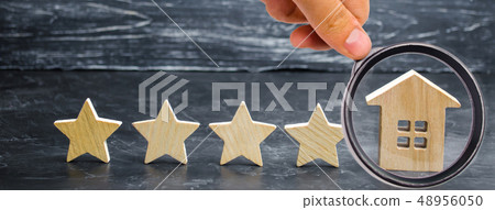 Five stars and a wooden house on a gray concrete Five stars and a wooden house on a gray concrete 48956050
