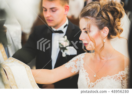 Wedding couple bide and groom get married in a church Wedding couple bide and groom get married in a church 48956280