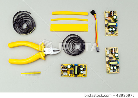 Yellow electronic device on gray background. Yellow electronic device on gray background. 48956975