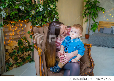 Happy young mother and her baby son sitting togerher 48957600