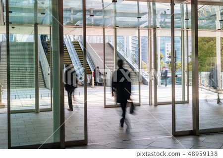 審閱一個自動門的商人在辦公室區域 審閱一個自動門的商人在辦公室區域 48959138