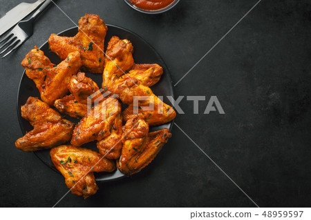 Chicken wings grilled in sauce on plate Chicken wings grilled in sauce on plate 48959597