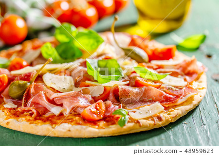 Appetizing italian pizza with prosciutto 48959623