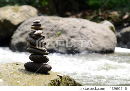 Stacked zen stone at Tegenungan Waterfall Stacked zen stone at Tegenungan Waterfall 48960346