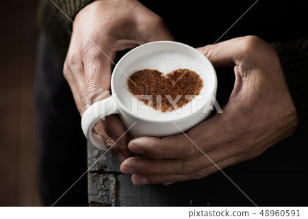 man with a cup of cappuccino with a heart man with a cup of cappuccino with a heart 48960591